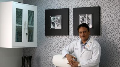 Dubai plastic surgeon Dr Sanjay Parashar in his Dubai office. He will fly to India next month to perform operations for free. Pawan Singh / The National