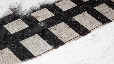 A woman walks in the central courtyard of the European Parliament, covered by fresh snow in Strasbourg, France. Reuters