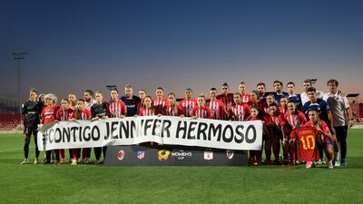 Atletico Madrid players and staff hold a banner in support of Spain's Jenni Hermoso. Reuters