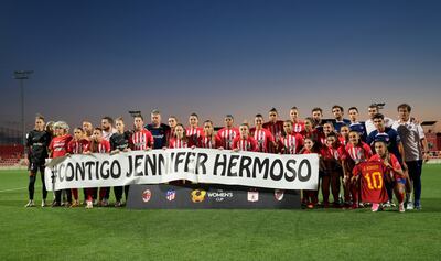 Atletico Madrid players hold up a banner saying 'with you, Jennifer Hermoso' as footballers rally to her side. Reuters