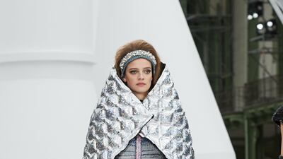 Chanel seems to have concocted this quilted metallic cape, which encases the body from ear to elbow, for an astronaut.