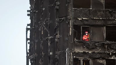 A fireman looks out from the remains of the Grenfell Tower in London at the weekend. Will Oliver / EPA