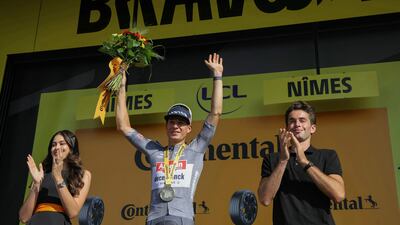 Alpecin-Deceuninck team's Belgian rider Jasper Philipsen celebrates on the podium after winning Stage 16. AFP