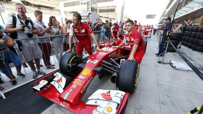 Members of the Ferrari crew walk through pit lane on Thursday ahead of Sunday's Abu Dhabi Grand Prix. Christopher Pike / The National
