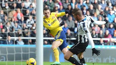 Adam Johnson of Sunderland shoots past Davide Santon of Newcastle United during their Premier League match at St James' Park on Saturday. Michael Regan / Getty Images