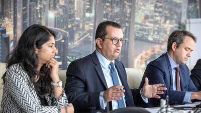 Mohamed Damak, senior director and global head of Islamic Finance (center), speaking during a media roundtable in Dubai on Monday. Antonie Robertson/The National