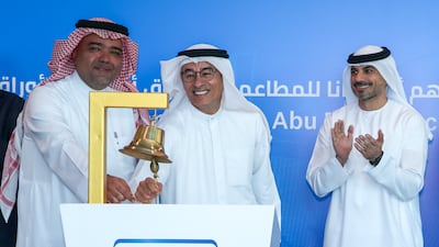Americana Restaurants chairman Mohamed Alabbar (centre) and the company's vice chairman Abdulmalik Al-Hogail ring the bell at the debut of the company's shares on the Abu Dhabi Securities Exchange (ADX) as Hisham Malak, chairman of ADX looks on. Americana, founded in Kuwait in 1964, introduced fast-food restaurants in the region in 1970. Photo: Victor Besa / The National