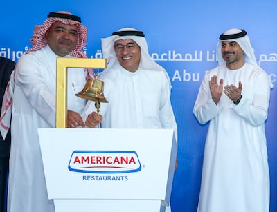 Americana's chairman Mohamed Alabbar, centre, rings the bell at the ADX. Victor Besa / The National