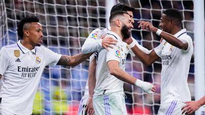 Real Madrid's Karim Benzema, centre, is congratulated after scoring his side's second goal from the penalty spot. AP Photo