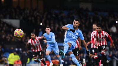 MANCHESTER, ENGLAND - FEBRUARY 09: Riyad Mahrez of Manchester City scores their side's first goal from the penalty spot during the Premier League match between Manchester City and Brentford at Etihad Stadium on February 09, 2022 in Manchester, England. (Photo by Gareth Copley / Getty Images)