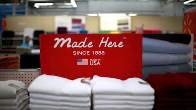 A stack of shirts on display at a Walmart Supercenter in Rogers, Arkansas. Walmart pledged in 2013 to buy an extra $250 billion in US-made goods over the next decade. Chris Keane / Reuters
