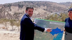 Israeli far-right Finance Minister Bezalel Smotrich displays a map of an area near the settlement of Maale Adumim, a land corridor known as E1, outside Jerusalem in the occupied West Bank in August. AFP