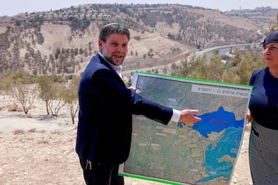 Israeli far-right Finance Minister Bezalel Smotrich displays a map of an area near the settlement of Maale Adumim, a land corridor known as E1, outside Jerusalem in the occupied West Bank in August. AFP