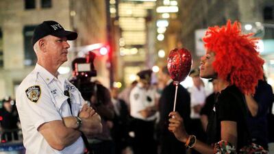 A woman offers a police officer a balloon during a Black Lives Matters protest outside in Manhattan, New York. Andrew Kelly / Reuters
