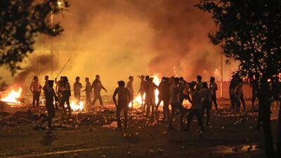 Iraqi protesters burn items to block a road during clashes with security forces following an anti-government demonstration in the Shiite shrine city of Karbala. AFP