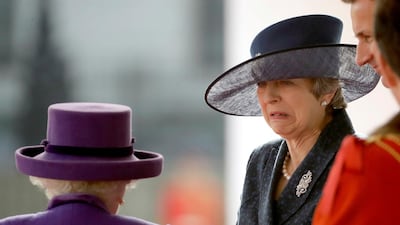 Britain's Prime Minister Theresa May talks to Queen Elizabeth as they wait to greet King Willem-Alexander and his wife Queen Maxima of the Netherlands at a Ceremonial Welcome during a state visit. Matt Dunham / AFP