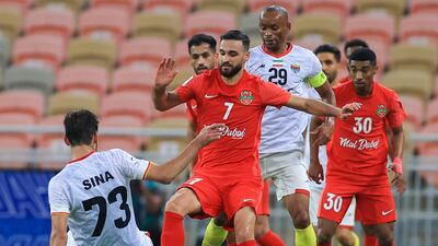 Shabab's midfielder Ahmad Nourollahi, centre, vies for the ball with Foolad's midfielder Sina Moridi during the AFC Champions League match at the King Abdullah Sports City stadium in Jeddah. AFP