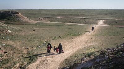 Civilians arrive at an SDF position on the outskirts of Bagouz. Getty Images