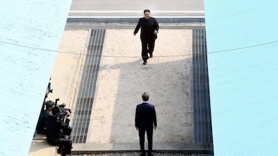North Korean leader Kim Jong-un, top, walks towards South Korean president Moon Jae-in, bottom, at the border village of Panmunjom. Korea Summit Press Pool via AP