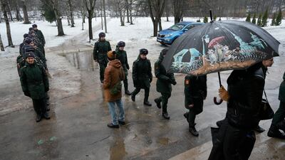 Russian service personnel enter a polling station in St Petersburg, Russia. AP