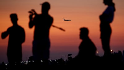 An aircraft is seen next to the people on the beach in Sochi as the number of the coronavirus disease cases grows in Russia. Reuters
