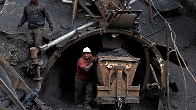 A coal miner pushes a metal cart loaded with coal at a mine near the city of Zirab. The miner move up to 100 tonnes of coal a day. Ebrahim Noroozi / AP Photo