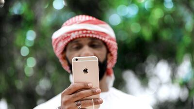 An iPhone is tested at the Apple Store ahead of its grand opening in Dubai in October. Kamran Jebreili / AP Photo