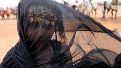 A Moroccan girl from the southern desert performs during a fantasia. AFP