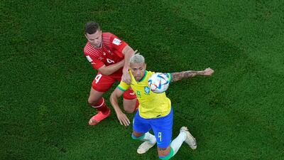 Brazil's Richarlison under pressure from Nico Elvedi of Switzerland. AP