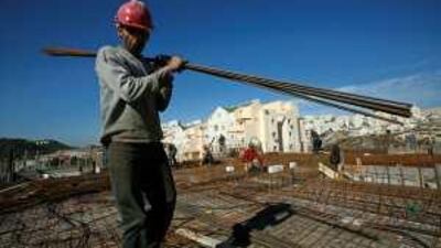 The OECD's statisticians says that if Jewish settlers are included in Israel's economic data, then the numbers should also include Palestinians in the occupied territories, such as this West Bank construction worker.