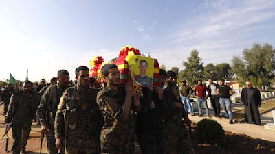 SDF personnel carry the coffin of a fellow fighter in the Kurdish-controlled city of Qamishli, northeastern Syria. AFP