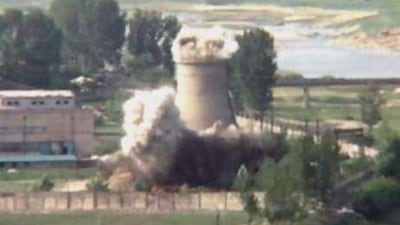 This image from television shows the demolition of the 18-metre-tall cooling tower at its main reactor complex in Yongbyon, North Korea.