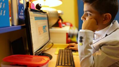 Yacoub Ali, 9, focuses on solving maths equations at his home in Abu Dhabi. Yacoub is one of the children given brain training by Dots & Links. Delores Johnson / The National