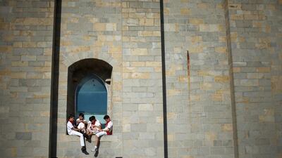 Youths relax sitting on the sill of a window during the second day of the San Fermin Running Of The Bulls festival in Pamplona, Spain. Christopher Furlong / Getty