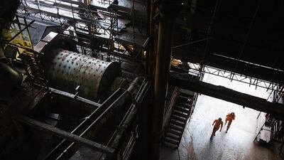 Workers walk into the main production area at the surface works of Cleveland Potash mine. Ian Forsyth / Getty Images