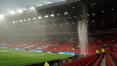 Rain cascades from the roof at Old Trafford after the Manchester United v Arsenal match, which Keir Starmer attended as a guest of Labour colleague Andy Burnham. AP