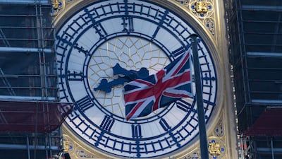 The Big Ben clock face with a Union Jack flag seen at dawn in Westminster, London. Britain left the European Union at 11pm on 31 December 2020. EPA