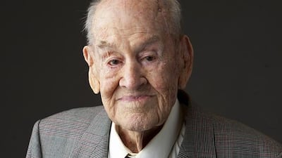 Paul Royle poses for a photo holding a picture of himself in uniform during during the Second World War on June 23, 2015, in Perth, Australia. Garry Sarre / Gordon Royle via AP