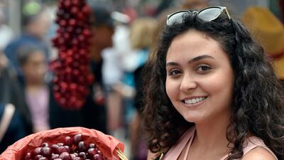 A woman poses as she carries a cherry basket during Cherry Day in the village of Hammana, southeast of Beirut, Lebanon. EPA