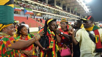 A Ghana’s supporter holds her face at the end of the 2015 African Cup of Nations semi-final football match between Equatorial Guinea and Ghana in Malabo, on February 5, 2015. Play was halted eight minutes from time in the Africa Cup of Nations semi-final between hosts Equatorial Guinea and Ghana when missiles were thrown on the pitch. AFP PHOTO / ISSOUF SANOGO