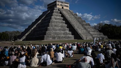 People watch as the shape of a serpent is cast in shadows on the El Castillo pyramid in Chichen Itza during spring equinox, in Yucatan State, Mexico. AFP