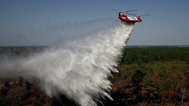 A Chinook water-bombing helicopter over France. Widespread drought has led to vast wildfires and a severe drop in Europe's crop yields. Reuters