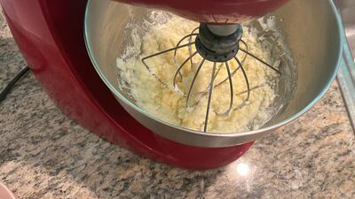 It took around 12 minutes for my cream to split into the butter and buttermilk. In the mixing bowl it looked a little like scrambled eggs. Farah Andrews / The National