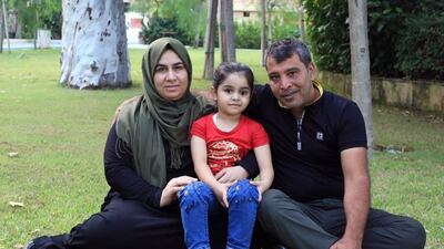 Sama, 5, with her parents. The Syrian girl lost an eye during the Beirut Port explosion but has since been fitted with a prosthetic. Wam