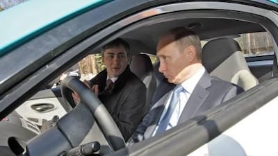 Russian Prime Minister Vladimir Putin sits behind the wheel of the Yo-mobile. EPA