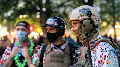 The Boogaloo Bois, an armed libertarian group, wearing their signature Hawaiian shirts during a protest in July 2020, in Portland, US. Getty