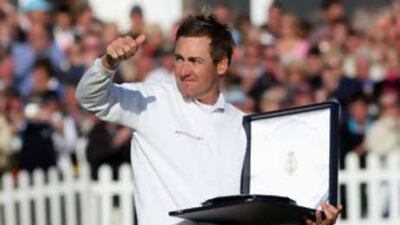 The English golfer Ian Poulter salutes the crowd as he receives the silver salver for finishing second during the 137th Open championship.