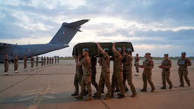 French military personnel carry the coffin of a compatriot killed in an attack on UN peacekeepers who were clearing a road in south Lebanon, at Beirut-Rafic Hariri Airport. Reuters