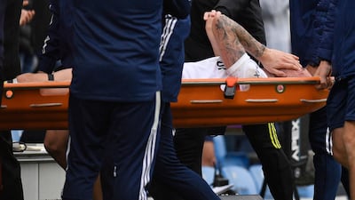 Leeds United midfielder Stuart Dallas is taken off on a stretcher after a collision with Jack Grealish. AFP