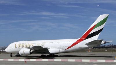 An Emirates A380 that suffered engine damage sits on the edge of the tarmac at Sydney international airport in Sydney, Australia, Monday, Nov. 12, 2012. The Emirates plane bound for Dubai was forced to turn back to Sydney Airport shortly after taking off on Sunday night after the captain informed passengers there was a problem with the No. 3 engine. (AP Photo/Rob Griffith)